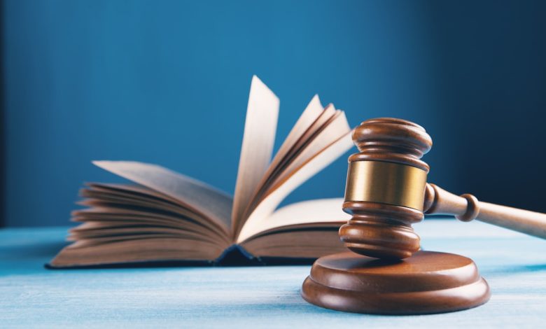 judges gavel and open book on table