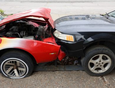 Cars are involved in a frontal collision.