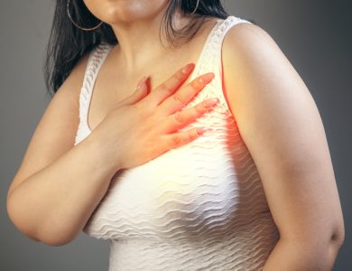 Woman holding her chest with a hand