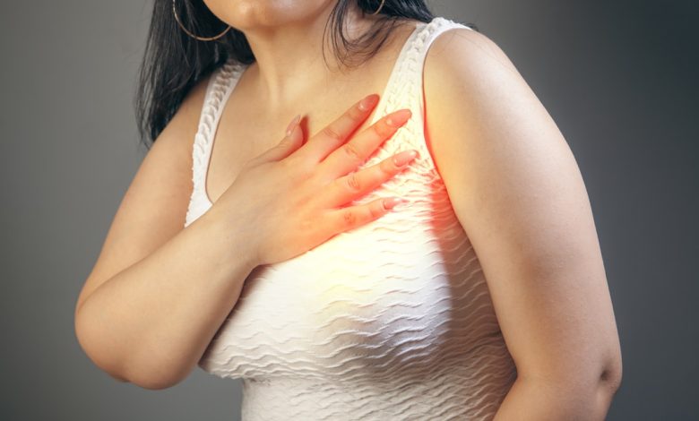 Woman holding her chest with a hand