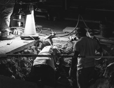 A black and white photo of men working in a factory