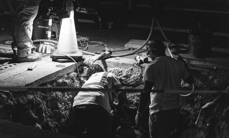 A black and white photo of men working in a factory