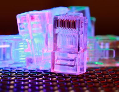 Vibrant close-up of network cable connectors with colorful lighting.