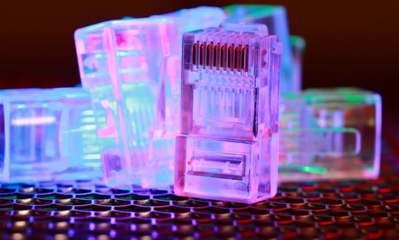 Vibrant close-up of network cable connectors with colorful lighting.