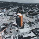 Drone photograph showcasing a cityscape with modern buildings and infrastructure.