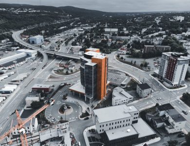 Drone photograph showcasing a cityscape with modern buildings and infrastructure.