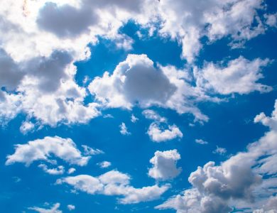 Vivid blue sky filled with fluffy white clouds, perfect for backgrounds.