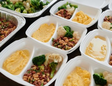 Assorted meal prep containers with beans, broccoli, and mashed potatoes, perfect for healthy eating.