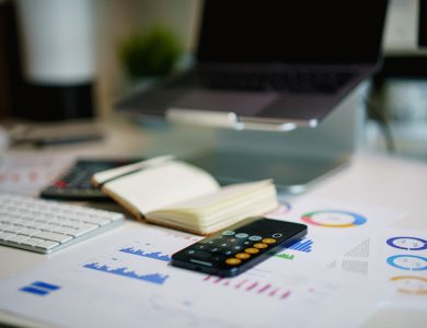 office desk with smartphone and financial charts