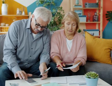 Elderly couple reviewing documents at home