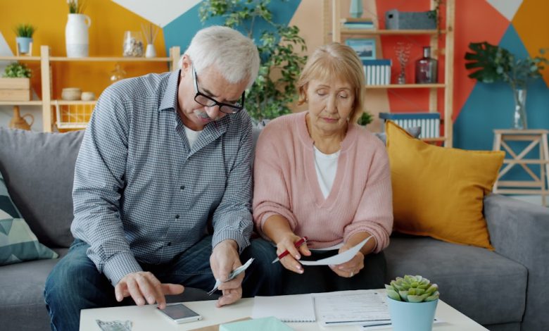 Elderly couple reviewing documents at home