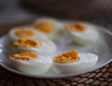 Close-up of sliced boiled eggs with soft yolks on a white plate, perfect breakfast or snack idea.