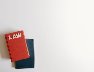 Flat lay of a red law book and a blue book on a white background, perfect for legal themes.